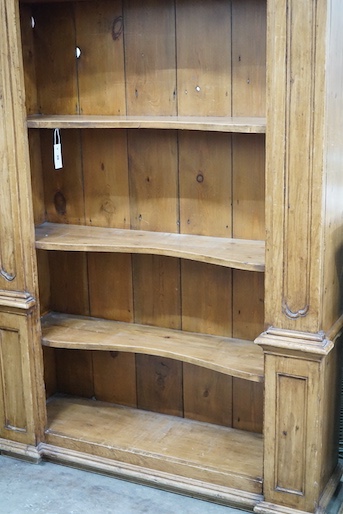 An 18th century style French provincial pine open bookcase, length 116cm, depth 28cm, height 204cm